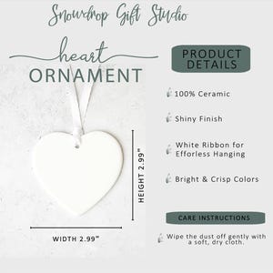 May include: A white heart-shaped ornament with a shiny finish, measuring 2.99 inches in width and height. It includes a white ribbon for hanging. The text on the image reads "heart ORNAMENT" and "Snowdrop Gift Studio."