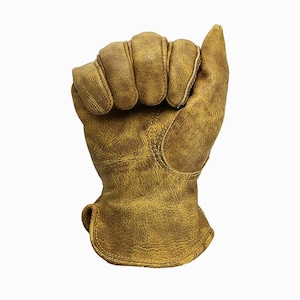 May include: A close-up of a work glove made of distressed brown leather. The glove is clenched into a fist, showcasing the stitching and texture of the material. The glove appears worn, suggesting durability and use.