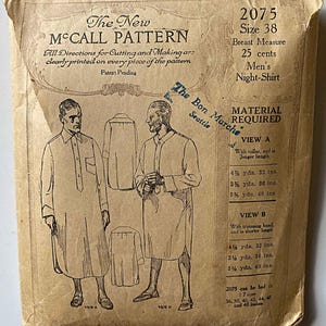 May include: Vintage McCall's sewing pattern for a men's night shirt, size 38. The pattern is printed on a tan paper with black ink. The pattern includes instructions for cutting and making the shirt, as well as a material requirements list. The pattern is for a shirt with a collar and a longer length, or a shorter length with a trimming band. The pattern is from The Bon Marche in Seattle.