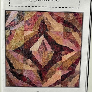 May include: A quilting pattern titled "Solstice" featuring a geometric design with a mix of red, brown, and beige fabrics. The pattern is from "A Quilter's Dream - if you love to quilt or love a quilter."