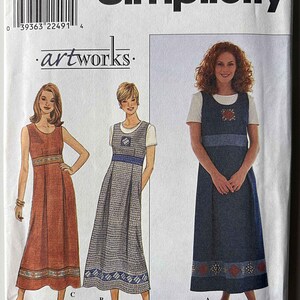 May include: A Simplicity 8515 sewing pattern envelope featuring three sleeveless dress variations. The designs include a solid rust-colored dress, a gray patterned dress, and a dark blue denim-style dress with embroidered floral accents.