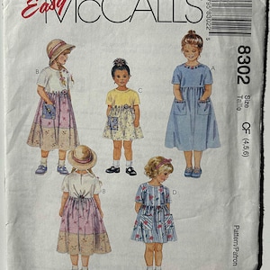 May include: A vintage sewing pattern from Easy McCall's featuring illustrations of children's dresses. The pattern includes multiple dress designs with various sleeve lengths, pocket styles, and skirt patterns. The pattern number is 8302, with sizes CF (4,5,6).