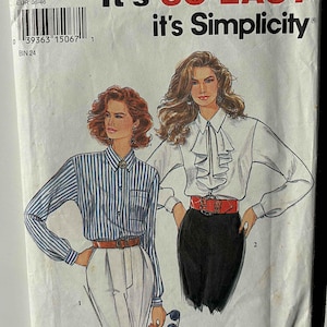 May include: A vintage Simplicity sewing pattern featuring illustrations of two women's blouses. The pattern includes the text "It's SO EASY it's Simplicity" and size information. The pattern is for sizes 8-18.