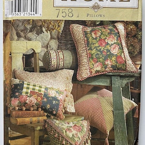 May include: Simplicity Home 758 pillow pattern. The image shows several pillows with floral and gingham patterns. The pillows are in various shapes and sizes, with decorative elements like tassels and ruffles. The pattern includes the text "ONE SIZE".