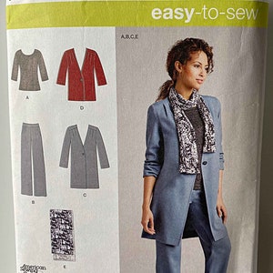 May include: Simplicity sewing pattern number 1073 R5, easy-to-sew, for sizes US 14-22, Euro 40-48, French 42-50. The pattern includes instructions for making a blazer, pants, and a top. The model is wearing a blue blazer, blue pants, and a gray top.