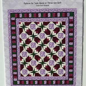 May include: A quilting pattern for a Tulip Twist quilt. The pattern is for a twin, queen, or throw size quilt. The quilt is pictured in a purple, green, and burgundy color scheme. The pattern is by Quilt Design Northwest and is called "Q123".