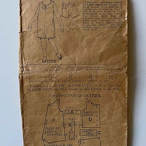 May include: Vintage sewing pattern for a child's combination undergarment. The pattern is for sizes 2, 3, 4, and 5 years. The pattern includes instructions for a closed back, round neck, perforated for square outline in front and back. The front of the undergarment is in one piece. The upper back edge of the drawers is gathered to a waist band and buttoned to the back of the waist. The pattern includes embroidery design No. 12367. The pattern is dated April 30, 1907.