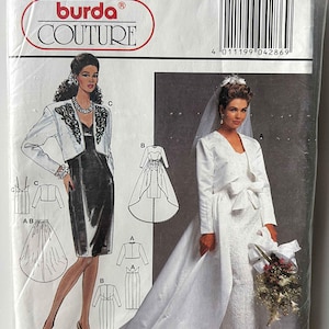 May include: A Burda Couture sewing pattern packet featuring illustrations of wedding and formal dresses. The packet includes a bride in a white gown and a woman in a black dress with a white jacket. The packet also includes size information.