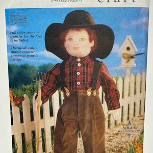 May include: Vogue Craft doll pattern #9783. The pattern includes instructions for a doll wearing a black hat, plaid shirt, brown corduroy pants, and suspenders. The pattern also includes a full-color iron-on transfer for the face.