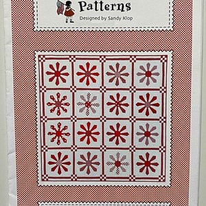May include: A quilting pattern booklet with a red and white gingham background. The cover features a red daisy quilt block design and the text "American Jane Patterns" and "Red Daisy".