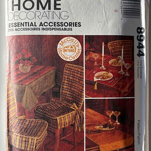 May include: A sewing pattern for home decorating accessories. The pattern shows a plaid chair cover, a table runner, and a placemat. The pattern is from McCall's Home Center and is number 8944.