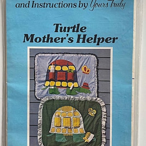 May include: A clear plastic package containing a patchwork pattern and instructions. The pattern is titled "Turtle Mother's Helper" and features two turtle designs. Finished size approximately 34" x 26".