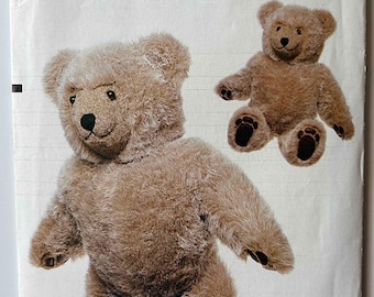 May include: Vogue Patterns 8658 Craft pattern featuring a teddy bear design. The cover shows a large, brown teddy bear and a smaller version. The pattern is designed by Linda Carr.