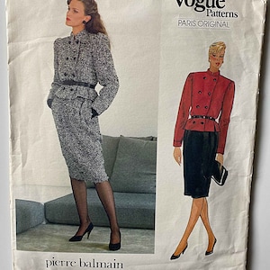 May include: Vogue Patterns Paris Original sewing pattern for a skirt suit by Pierre Balmain. The pattern features a black and white tweed skirt suit with a red jacket and a black skirt. The pattern number is 1231.