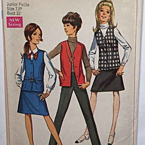 May include: Simplicity sewing pattern number 7875 for a junior petite size 7JP with a bust measurement of 32 inches. The pattern includes three different outfits: a blue vest and skirt, a red vest with a turtleneck, and a black and white checkered vest with a white blouse. The pattern is from the 1960s and features a vintage style.