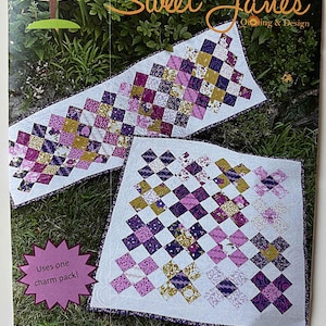 May include: A flyer for a quilting project titled "Ducks in a Row" by Sweet Jane's. The design features two quilted pieces with a checkerboard pattern in shades of purple, gold, and white. The flyer includes the text "Uses one charm pack!"