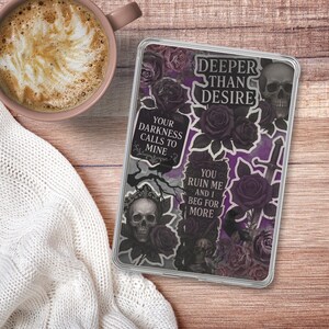 May include: A phone case with a gothic design featuring skulls, roses, and phrases like "Deeper Than Desire" and "You Ruin Me and I Beg For More." The case has a purple and black color scheme.