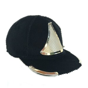 May include: A black fur baseball cap with a silver metal trim and a silver metal mesh panel on the front.