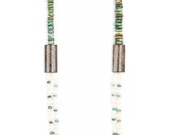 May include: A multi-strand necklace with white pearls and turquoise beads. The necklace has two silver rectangular clasps with engraved designs.