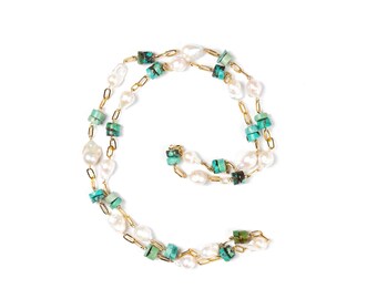 May include: A gold chain necklace with white pearls and turquoise stones. The necklace is layered and has a delicate design.