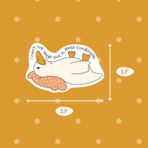 May include: A sticker featuring a cartoon duck lying on its back with the text "I can't live laugh love in these conditions." The sticker is approximately 2.7 inches wide and 1.7 inches tall. The background is mustard yellow with white polka dots.