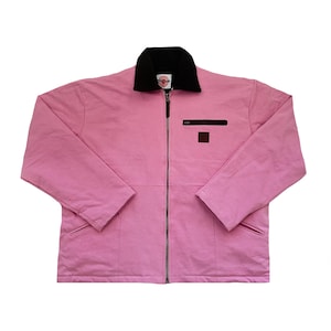 May include: A pink work jacket with a black corduroy collar and a zip closure. The jacket has a small pocket on the left chest and two pockets on the bottom.