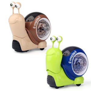 May include: Two toy snail cars. One is tan and brown, the other is green and blue. Each has a light-up shell with the text "LOVELY CAR". The snails have large eyes and sit on wheels.