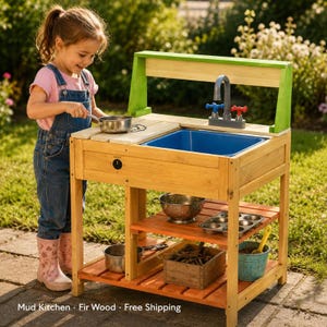 May include: A wooden mud kitchen featuring a blue plastic sink basin, a gray faucet with red and blue handles, and a black knob. The structure includes two lower shelves holding a metal colander, a muffin tin, a wooden crate, and a blue bucket.
