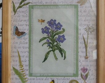 Framed Purple Wildflower Cross Stitch with Dragonfly Charm on Nature Themed Mat