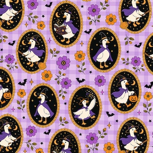 May include: A repeating pattern featuring white ducks dressed as witches in purple capes and black hats, enclosed in ornate gold oval frames. The background is a light purple gingham check with small orange flowers, stars, and black bats.