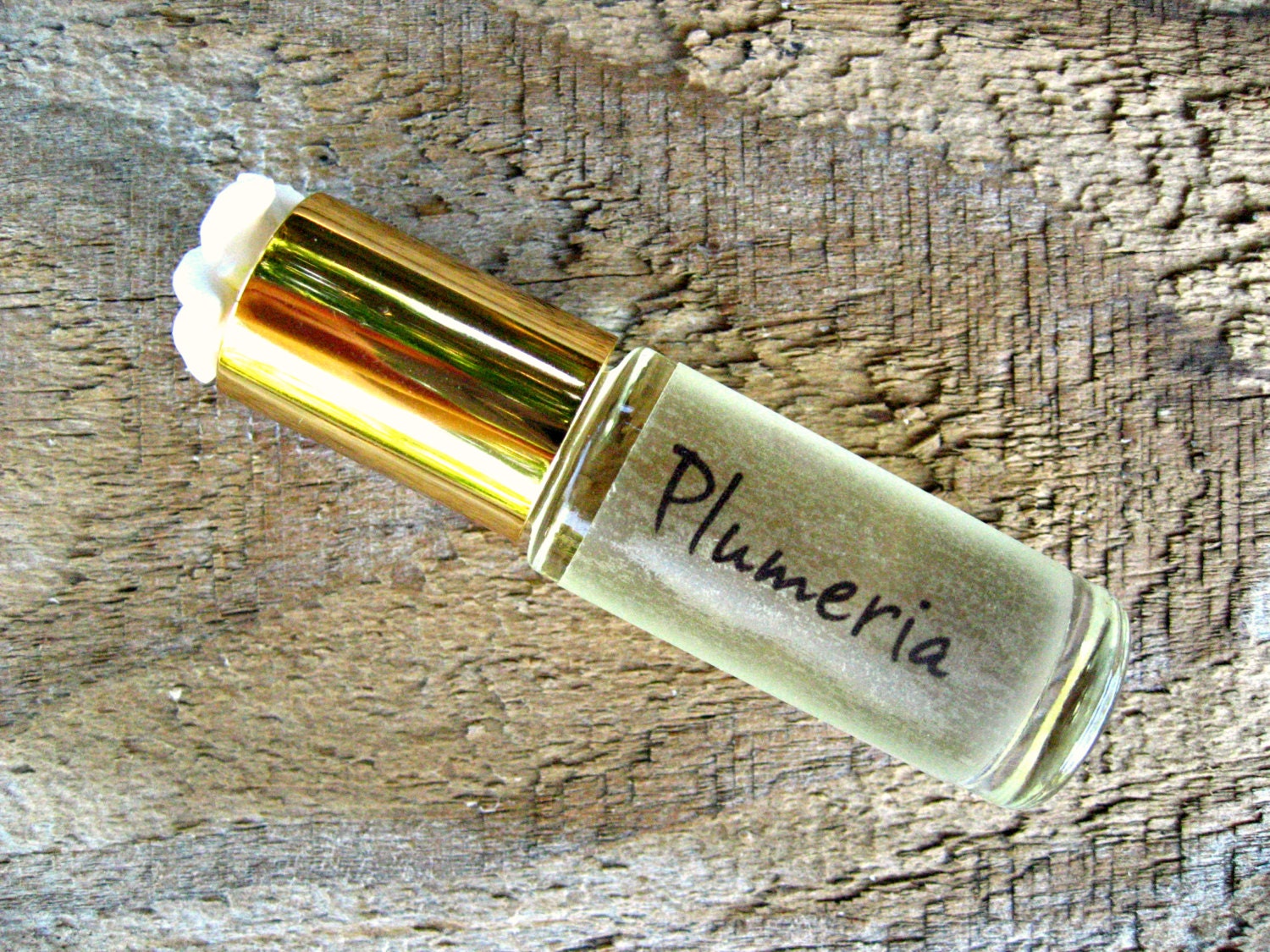 Plumeria Flowers Plumeria Essential Oil Perfume Wooden Table Stock Photo by  ©amylv 219571840