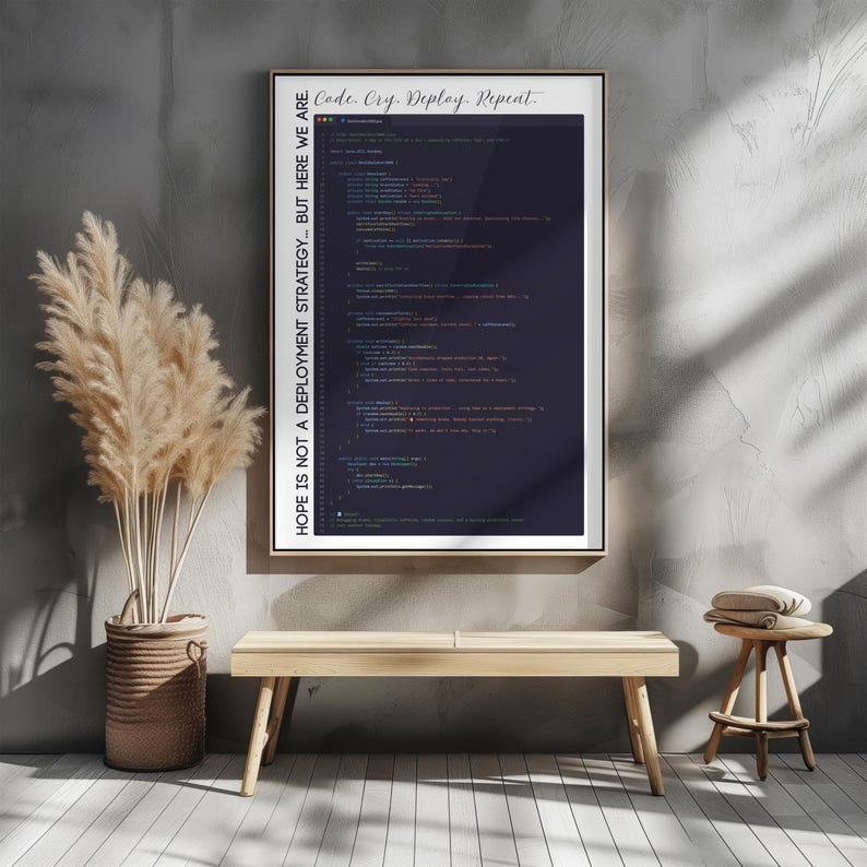 May include: A framed print with a dark blue background featuring lines of computer code. The top of the frame reads "Code. Cry. Deploy. Repeat." and the left side reads "HOPE IS NOT A DEPLOYMENT STRATEGY... BUT HERE WE ARE."