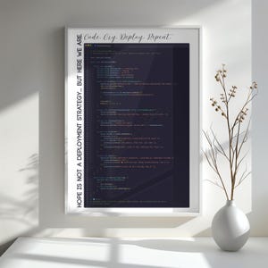 May include: A framed print with the text "Code. Cry. Deploy. Repeat." in a cursive font at the top. The print features lines of code in a dark colour, with the text "HOPE IS NOT A DEPLOYMENT STRATEGY... BUT HERE WE ARE." on the left side.