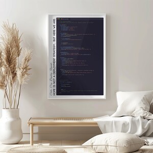 May include: A framed print featuring lines of computer code in various colors against a dark background. The white frame surrounds the image, and text on the side reads, "Code. Cry. Deploy. Repeat. HOPE IS NOT A DEPLOYMENT STRATEGY... BUT HERE WE ARE."