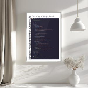 May include: Framed print featuring computer code on a dark background. The text "Code. Cry. Deploy. Repeat." is at the top, and "HOPE IS NOT A DEPLOYMENT STRATEGY... BUT HERE WE ARE." is on the left side. The print is displayed on a white wall.