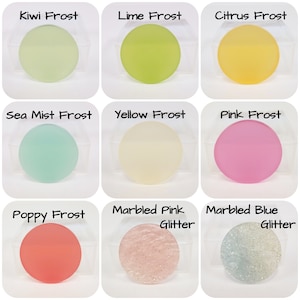 May include: Nine round, frosted glass pieces in various colors, including green, yellow, pink, and blue. Each piece is labeled with a color name, such as "Kiwi Frost" and "Pink Frost". Two pieces have glitter.