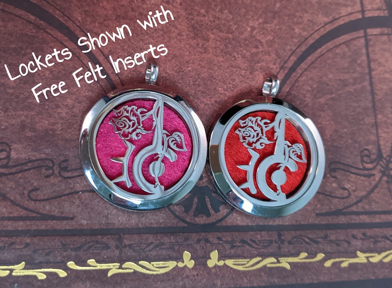 May include: Two silver-colored, round lockets with a rose and musical note design. One locket has a pink felt insert, the other has a red insert. The text "Lockets Shown with Free Felt Inserts" is visible.