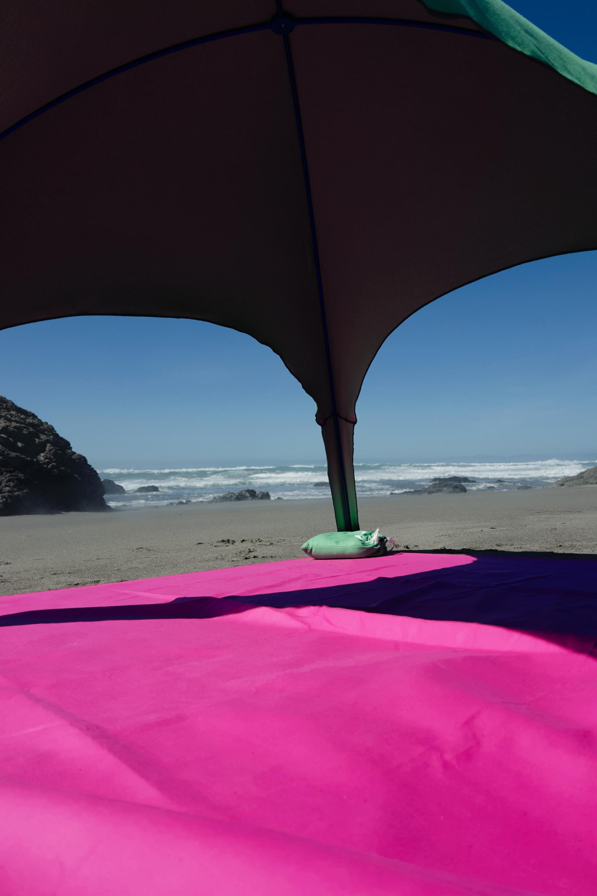 A portable beach tent perfect for sun protection and relaxation. Made from Suede microfiber towels. Pink & Green, more colors available.