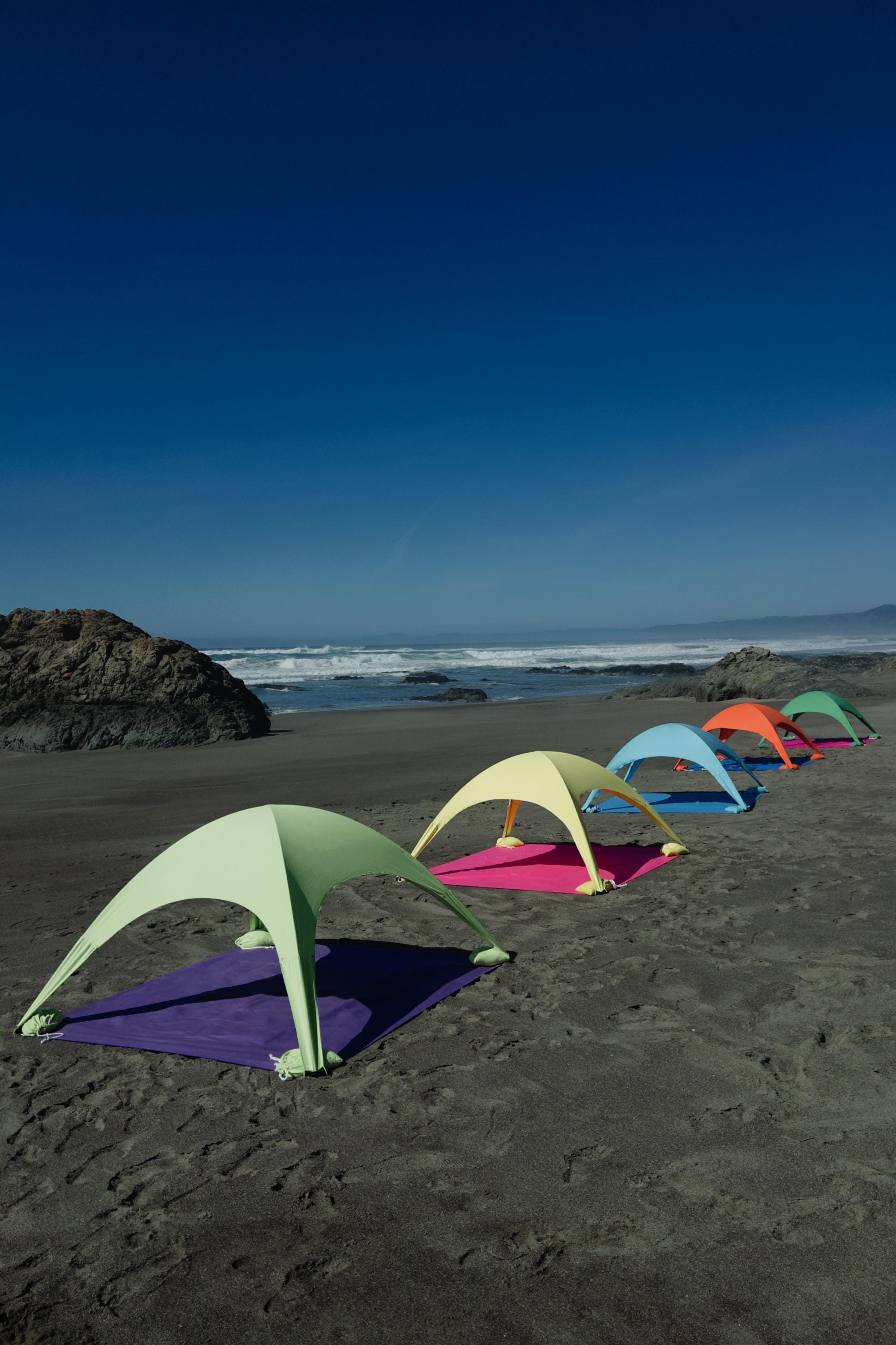A portable beach tent perfect for sun protection and relaxation. Made from Suede microfiber towels. Pink & Green, more colors available.