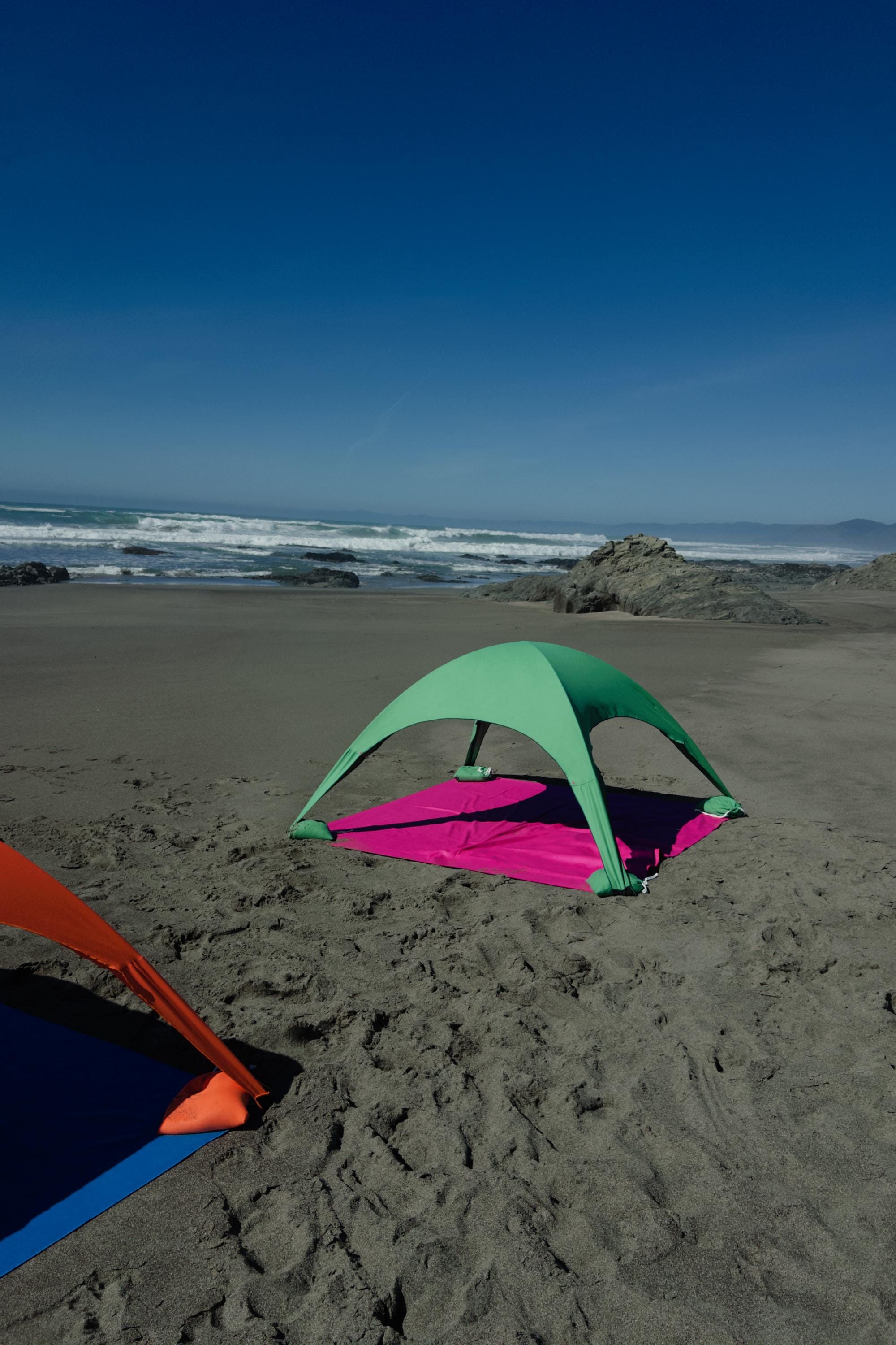 A portable beach tent perfect for sun protection and relaxation. Made from Suede microfiber towels. Pink & Green, more colors available.