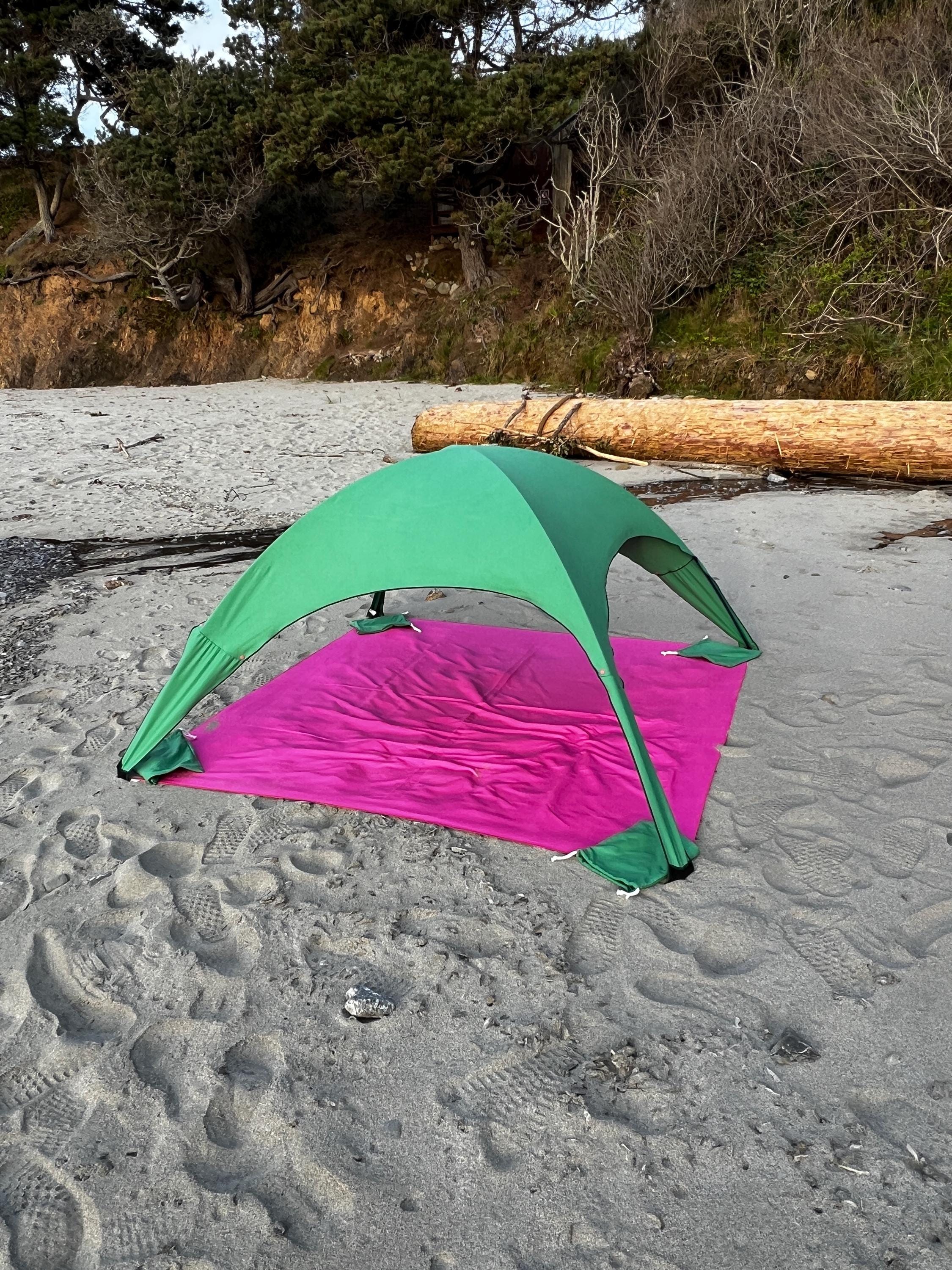 A portable beach tent perfect for sun protection and relaxation. Made from Suede microfiber towels. Pink & Green, more colors available.