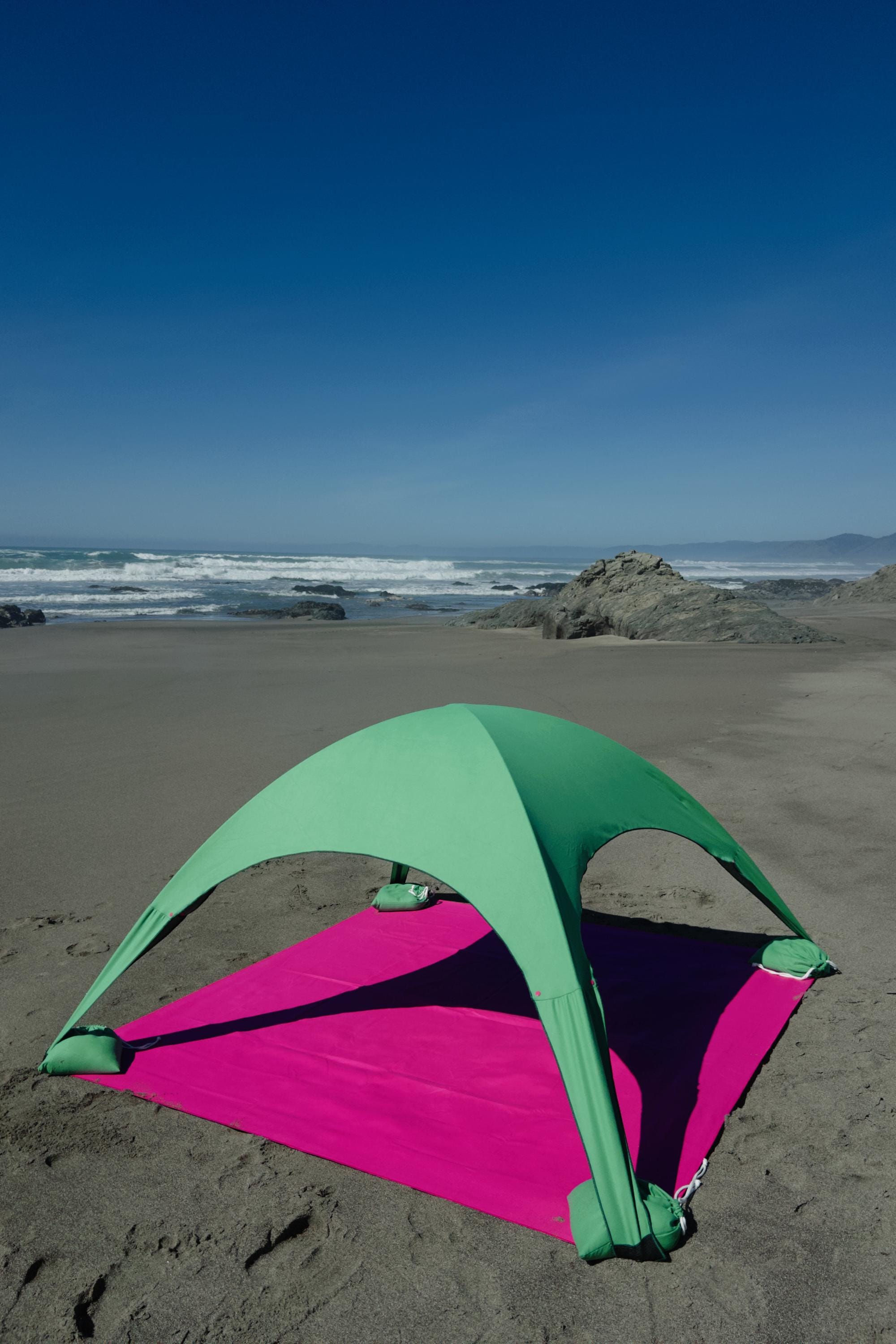 A portable beach tent perfect for sun protection and relaxation. Made from Suede microfiber towels. Pink & Green, more colors available.