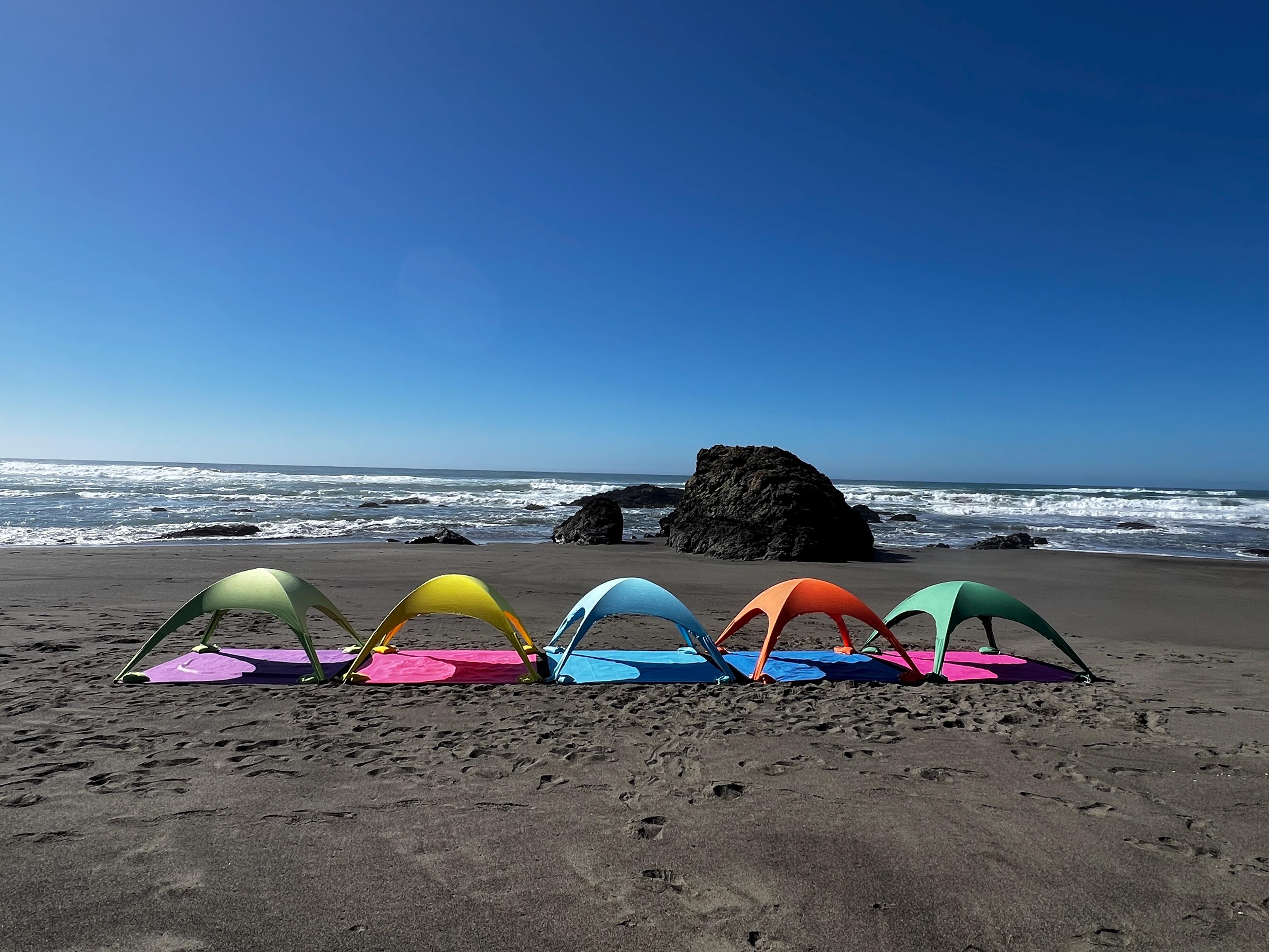 A portable beach tent perfect for sun protection and relaxation. Made from Suede microfiber towels. Pink & Green, more colors available.