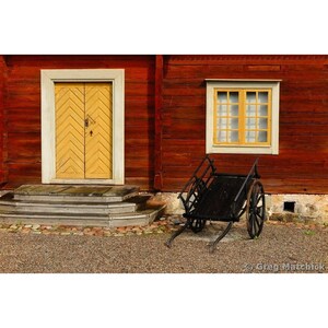 Fine Art Color Photography of Rustic Black Cart in Front of a Home in Sweden