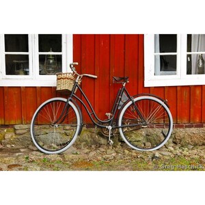 Fine Art Color Photography of a Bicycle Against a Red Home in Sweden