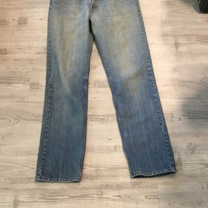 Levi Jeans 519 Distressed Levi’s Jeans Orange Levi tag on back Pocket Straight Legs Zipper Fly Orange Levi Tag