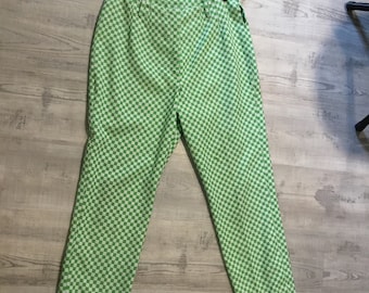 May include: Green and white checkered pants hanging on a hanger. The pants are a straight leg style.