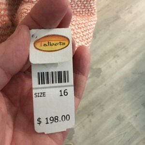 May include: White tag with black barcode, text "Talbots", "SIZE 16", and "$ 198.00".
