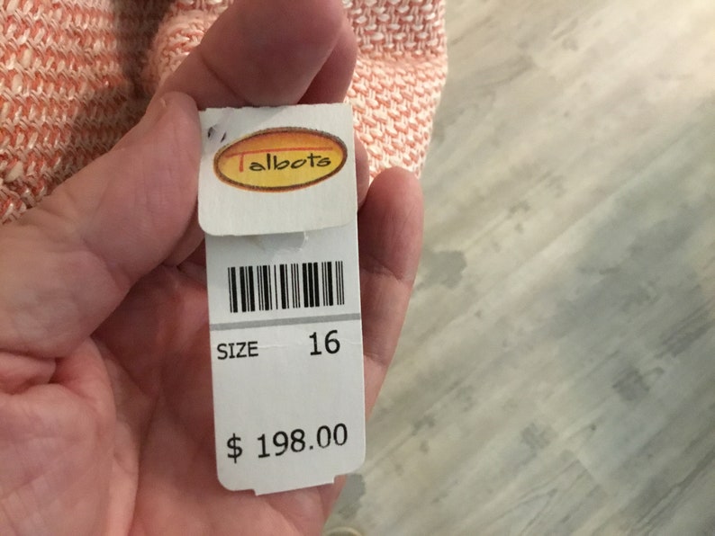 May include: White tag with black barcode, text "Talbots", "SIZE 16", and "$ 198.00".
