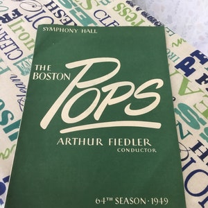 May include: A green program for The Boston Pops Orchestra, 64th Season, 1949, with the conductor Arthur Fiedler's name in white lettering.